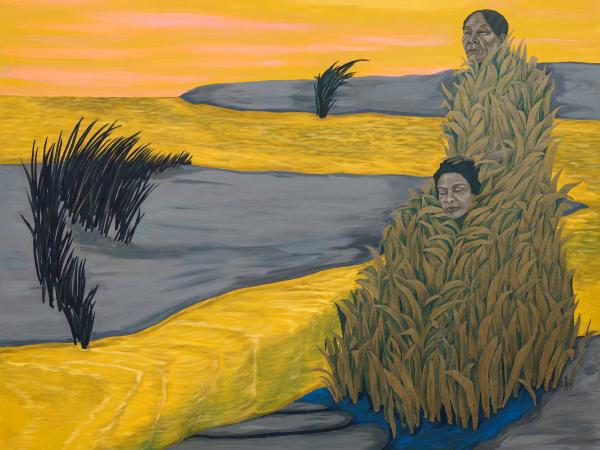 Two figures covered in grass in a bright yellow field