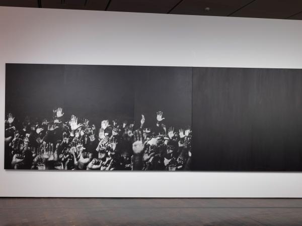 'Hands (Diptych)' by Glenn Ligon, black and white photograph of hands reaching upwards, with a fully black panel next to it. 