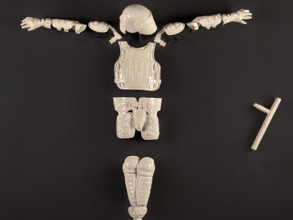 'God Complex,' by Nicholas Galanin which features a white porcelain police suit in a crucified pose. 