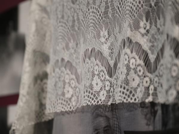 Mixed media installation of a cloth with a photograph of an older man embroidered within