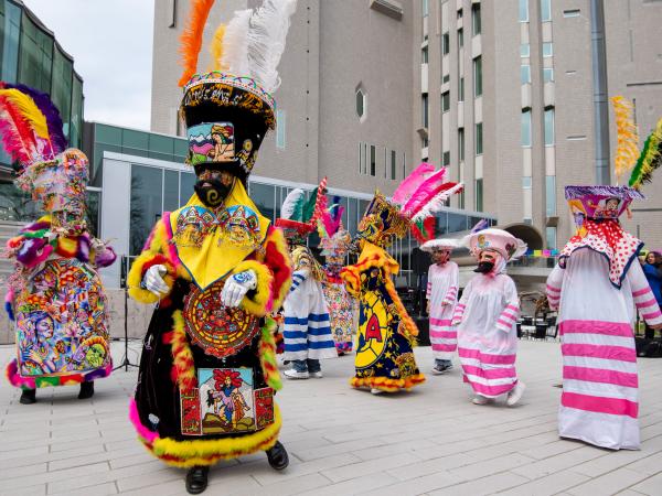 Group of performers dressed in colorful traditional clothing