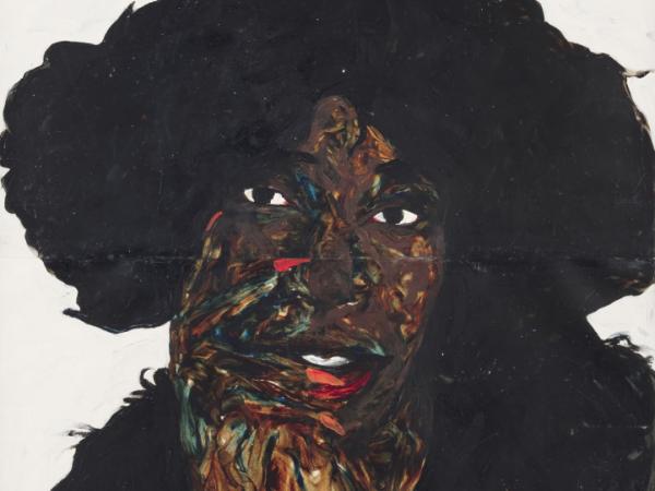 Black woman resting her head on one of her hands