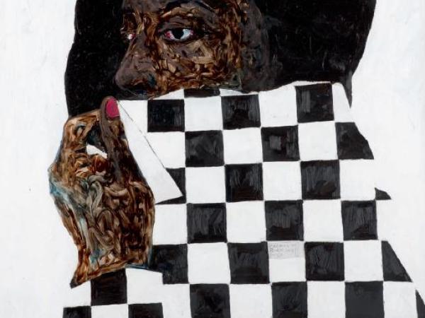 Portrait of a Black woman covering up the bottom of her face with a black and white checkered cloth
