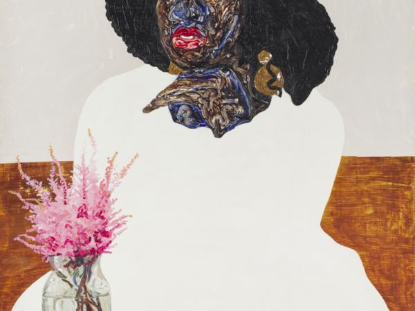 Black woman in white clothing next to a vase containing pink flowers