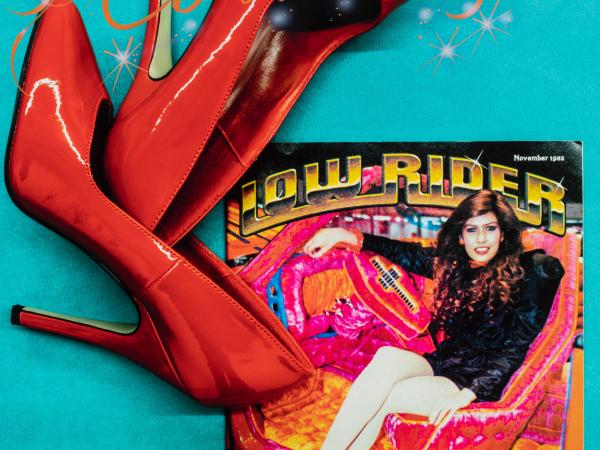 Promotional poster featuring a woman sitting in a low rider alongside large red high heels