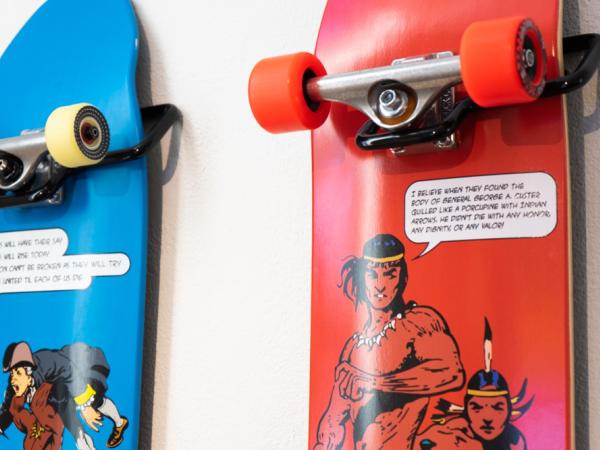Blue and red skateboards with graphic novel-like drawings