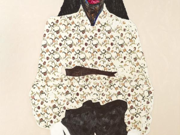 Black woman wearing a patterned top and white gloves
