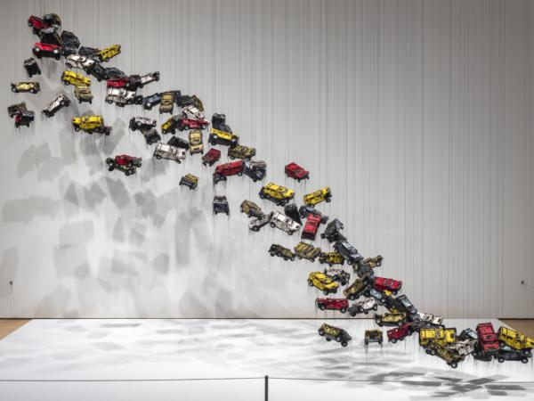 Installation made out of vinyl and thread with car model parts