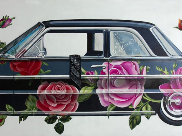 Low rider car decorated in bright red and pink floral arrangements