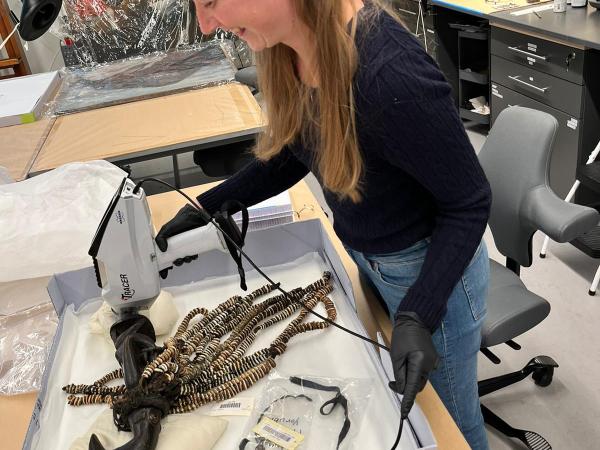 woman working on Esu in conservation lab