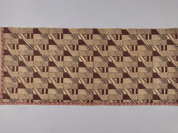 Indonesian cotton sarong with repeating brown block and dot patterns