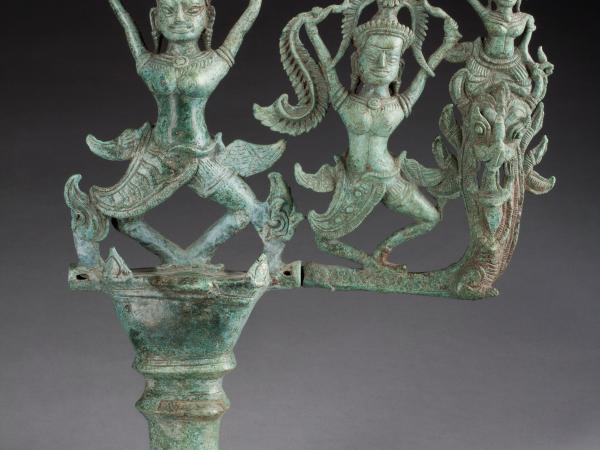 Three figures atop a chariot ornament