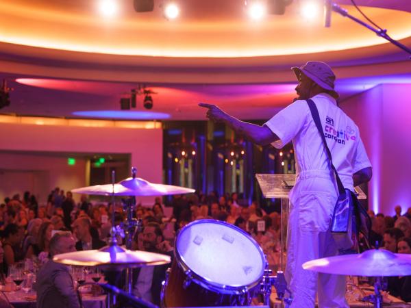 Man on stage pointing out to the crowd