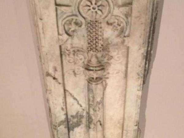 Vertical marble slab with circles and patterns carved in
