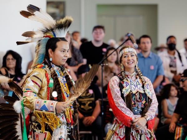 A man and woman performing at Powwow