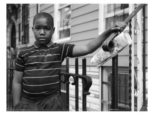 Young black boy posing near a stoop