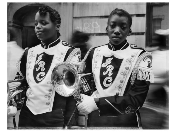 Two young Black girls in their marching band school uniforms