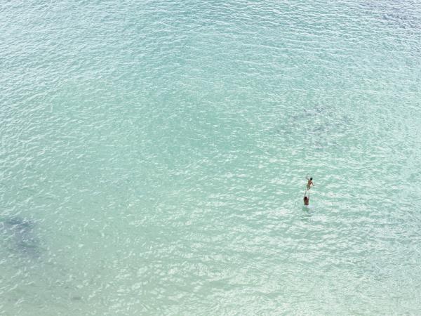 Woman maroooned in the light blue ocean waters