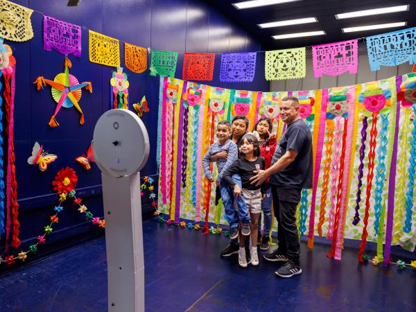 Family of visitors posing for a group photo at Dia Del Nino in 2024