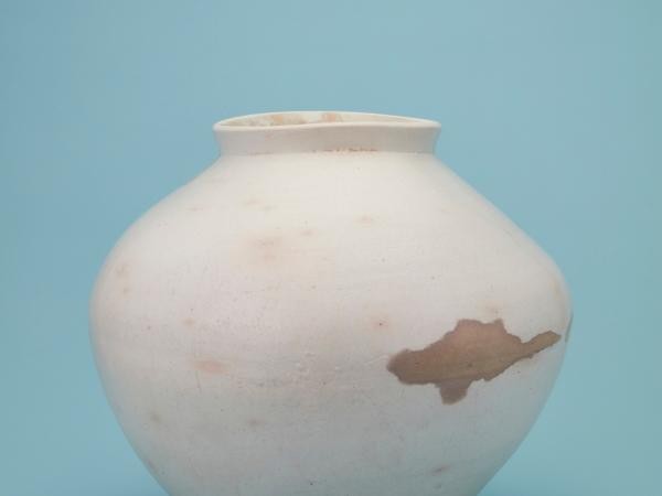 Porcelain with clear glaze against a light sky blue background