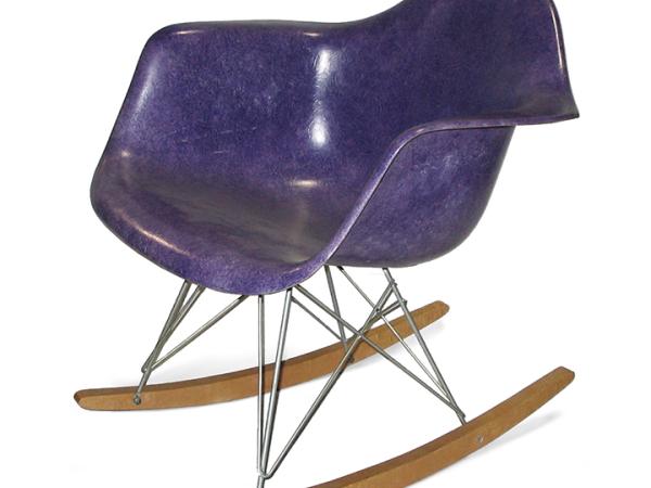 Purple rocker chair made out of fiberglass and wood