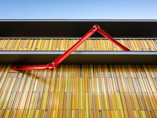 Outdoor red abstract sculpture adorning the Kirkland Museum building