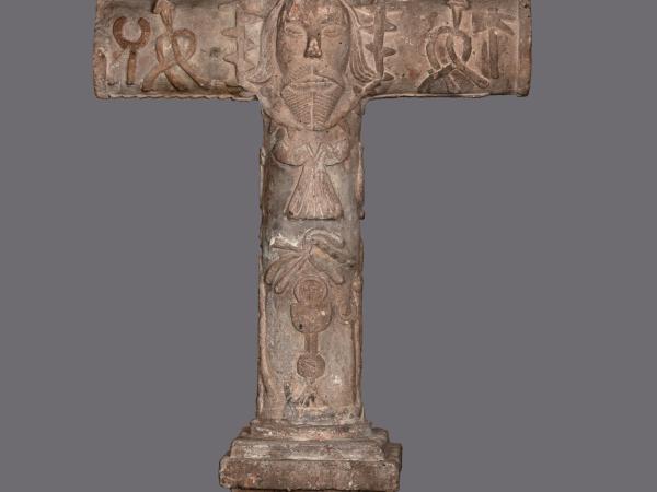 Small sculpture of a cross made out of volcanic stone