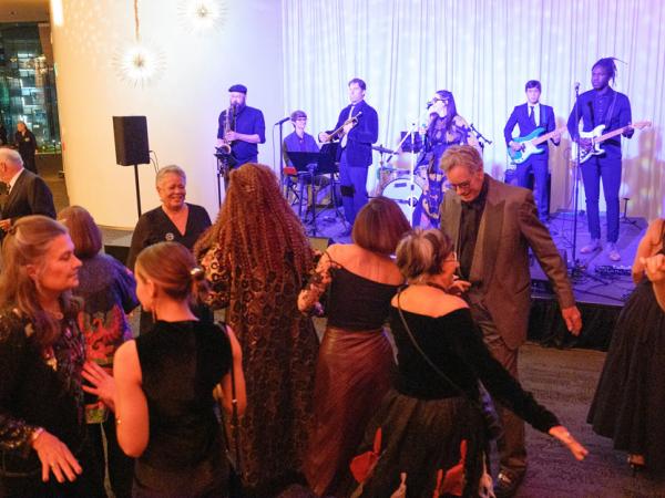 Group of adults dancing at a black-tie event