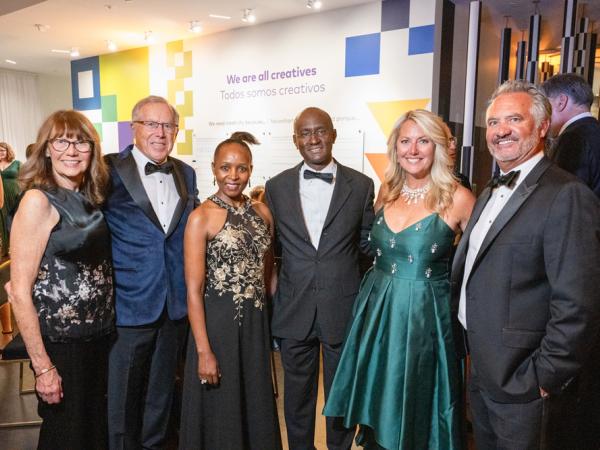 Group of well-dressed adults posing for the camera at a black-tie event