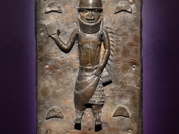 Plaque of a helmeted figure in a warrior pose