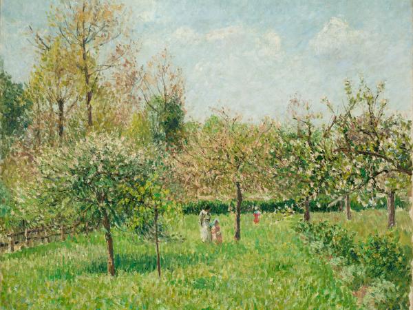 Mother and daughter walking through green trees and grass in the springtime