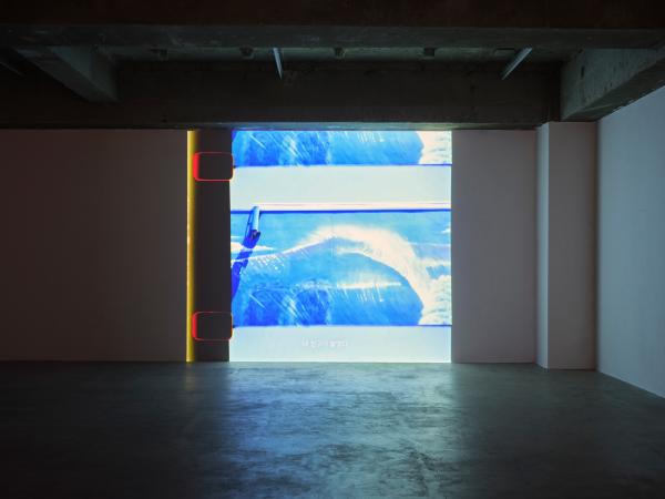 Video installation in empty warehouse-like gallery space