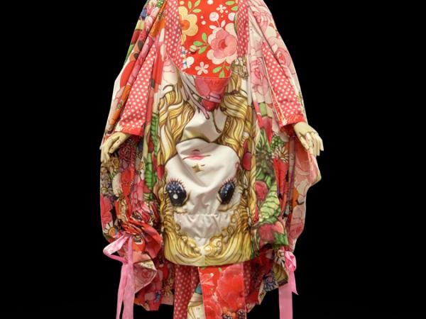 Japanese coat dress with bright designs resembling a face and floral patterns