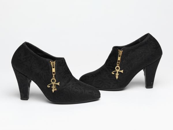 Bewjewling shoes with a zipper with the Prince symbol charm