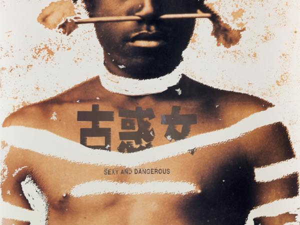 Barechested Aboriginal man with "sexy and dangeros" written across his chest