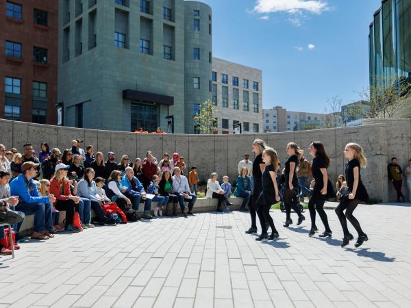 Young dancers performing before a large crowd outside at Dia del Nino