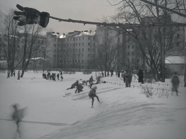 Kids skating on a snowy ice rink