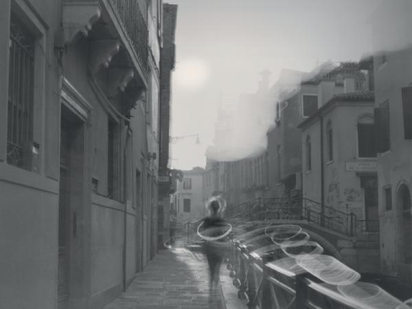 Man walking down the street with circles of light encase around him