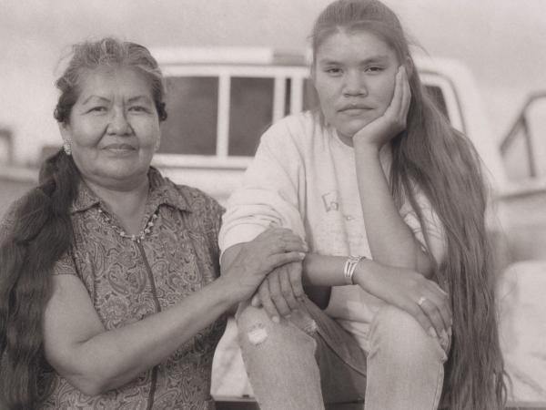 Indigenous mother and daughter in a black and white photo