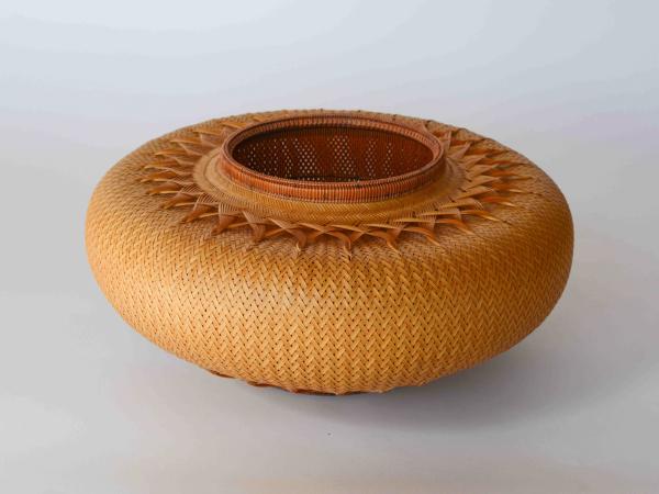 Round bamboo basket with an opening in the center