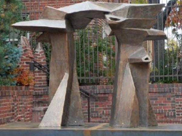 Abstract linked stone structures, connected at the top and made to resemble an archway