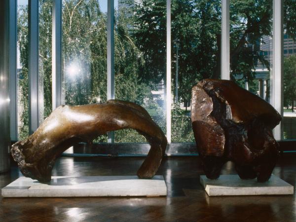 Two bronze statues resembling a large, oversize bull horn and bull skull