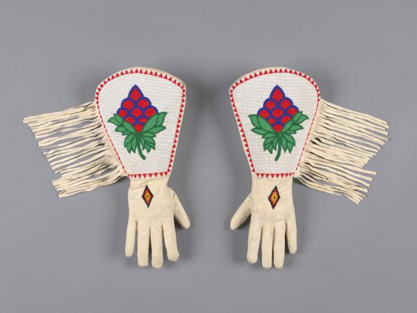 Leather and beaded white gloves with a flower pattern on the hand