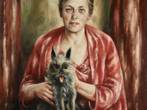 Portrait of a woman wearing a red shawl with a small fluffy dog in her lap