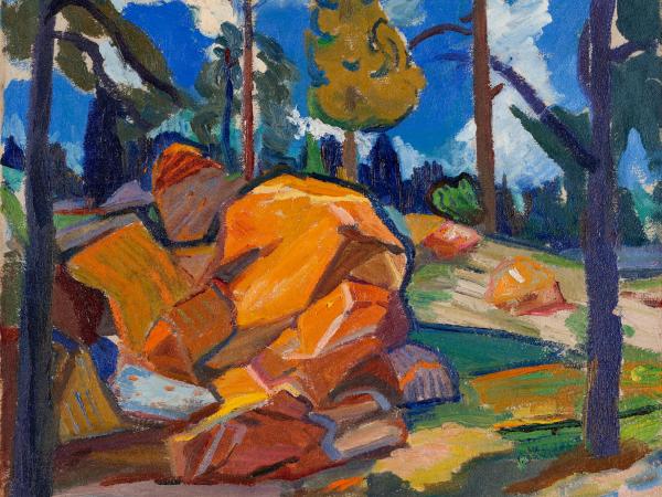 Bright orange rocks in a forest clearing and a bright blue sky