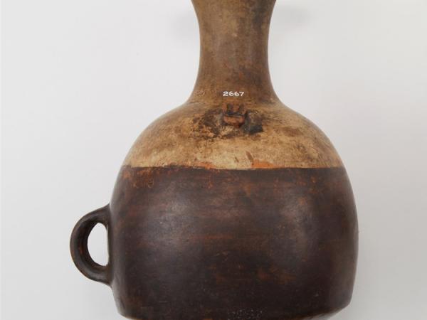 Brown and orange ceramic jug with spiral spout