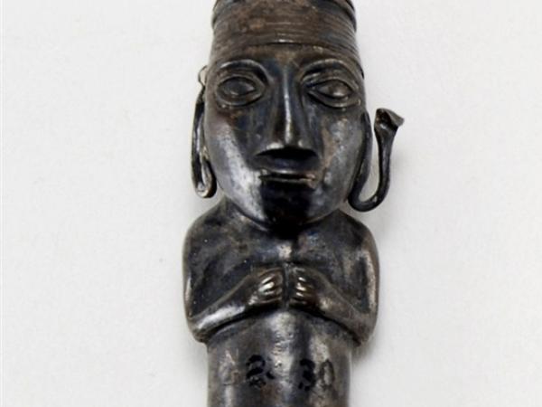 Male bronze statue figure standing with arms to the chest