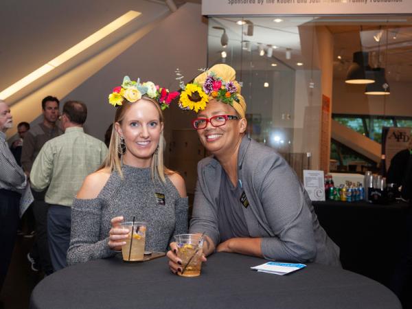 two women with cocktails and flower crowns at Untitled Final Friday