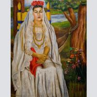 Woman in bridal clothing posing for a portrait.