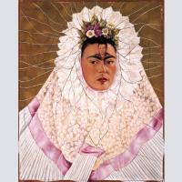 Frida Kahlo in long white gown with the image of Diego Rivera painted on her forehead.